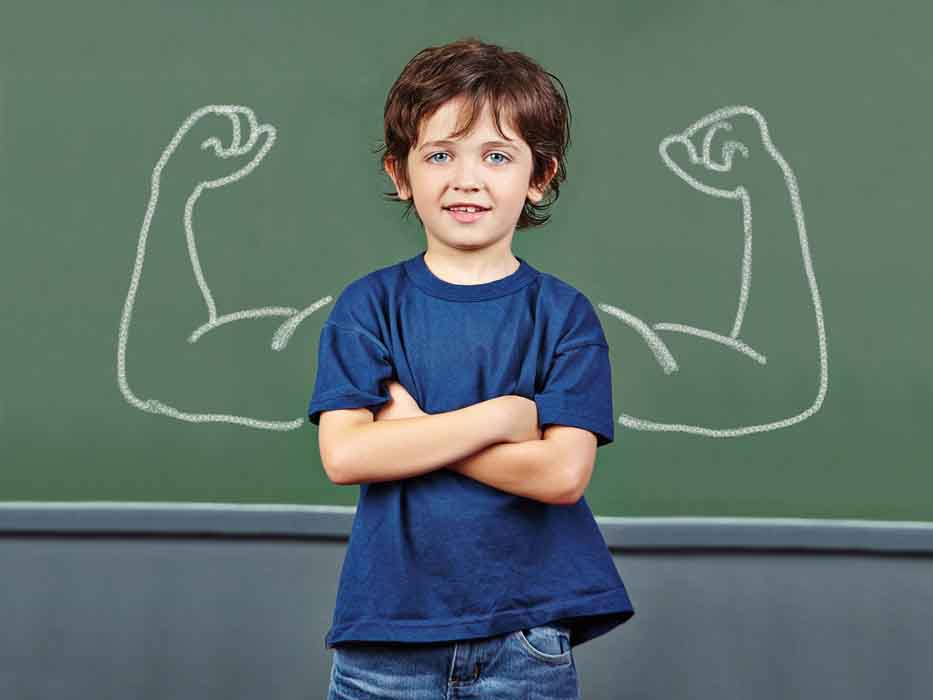 Strong child with muscles drawn on chalkboard in elementary scho